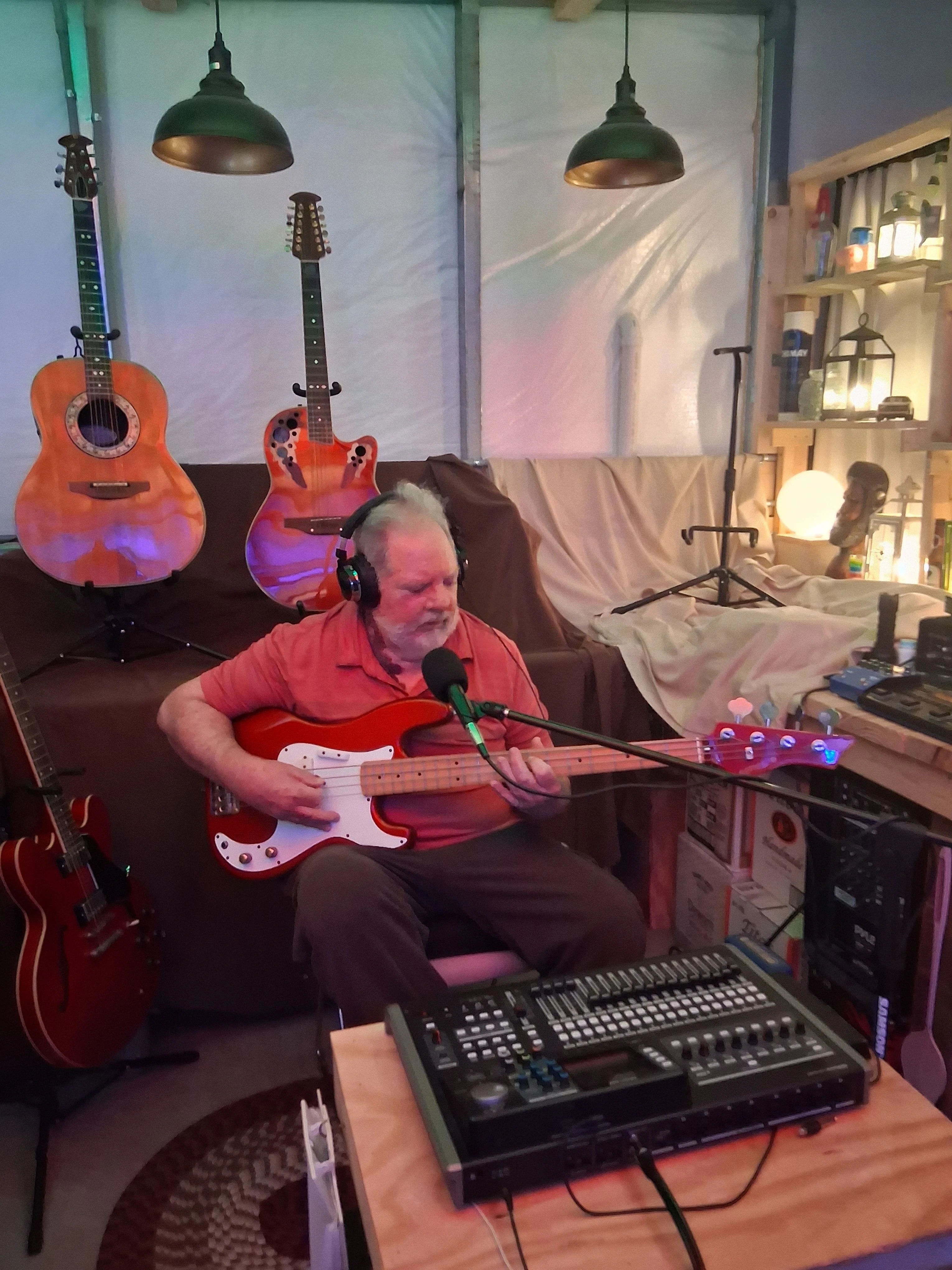 John Alvah in his studio John Alvah playing his 1985 Bentley series 10 long-necked electric bass in his studio